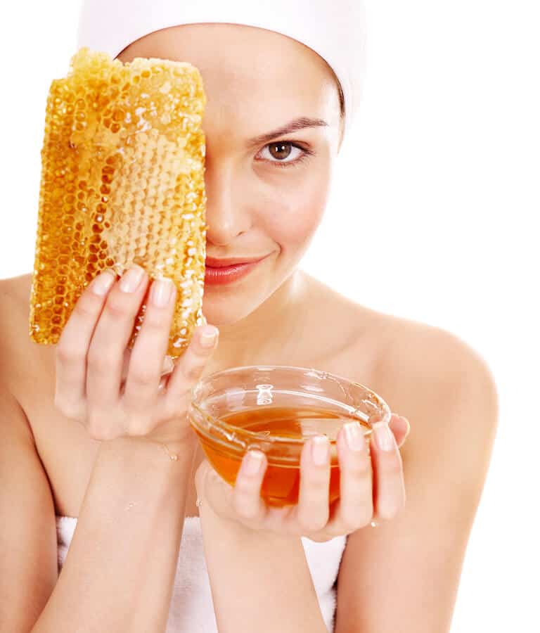 Lady Holding a Bar of Honeycomb and a Bowl of Honey